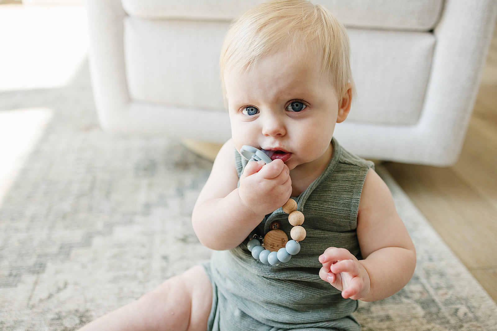 Ali + Tings pacifier clip attached to baby outfit
