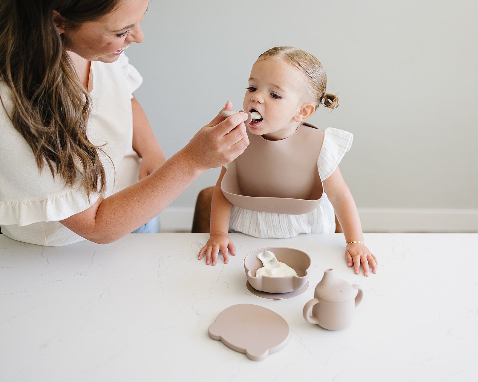 toddler eating with food-grade silicone bib