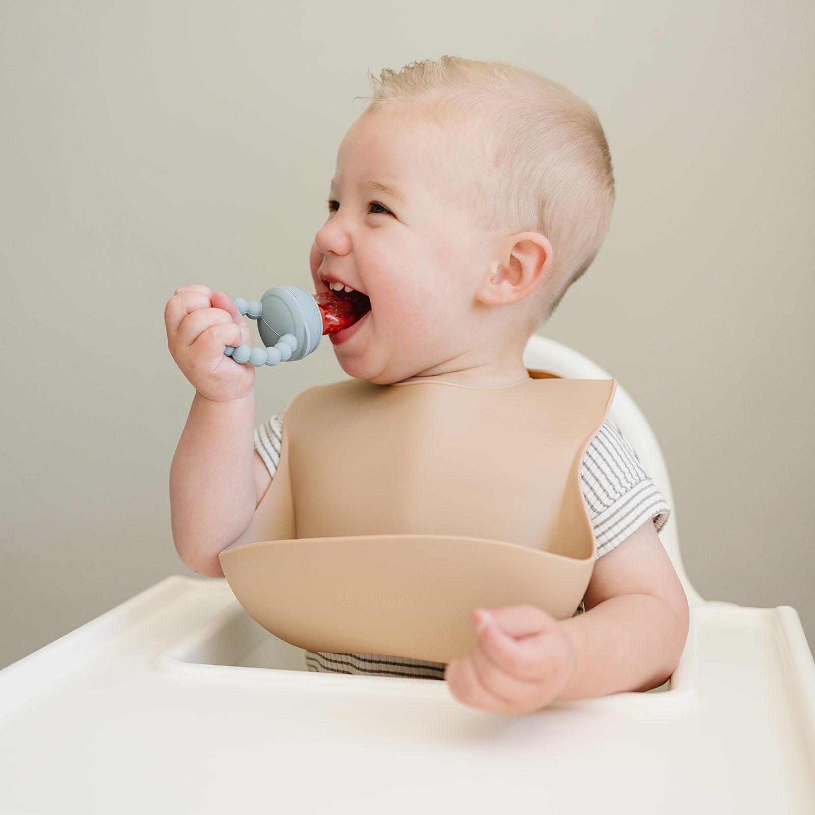 baby using pacifier fruit feeder 