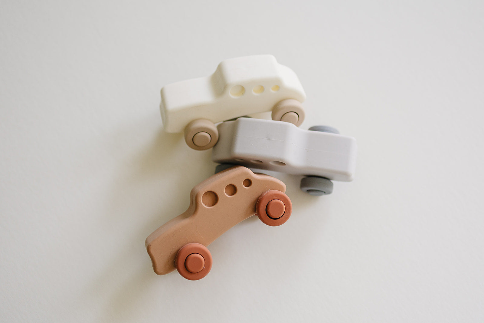 three soft silicone toddler cars in colorful designs