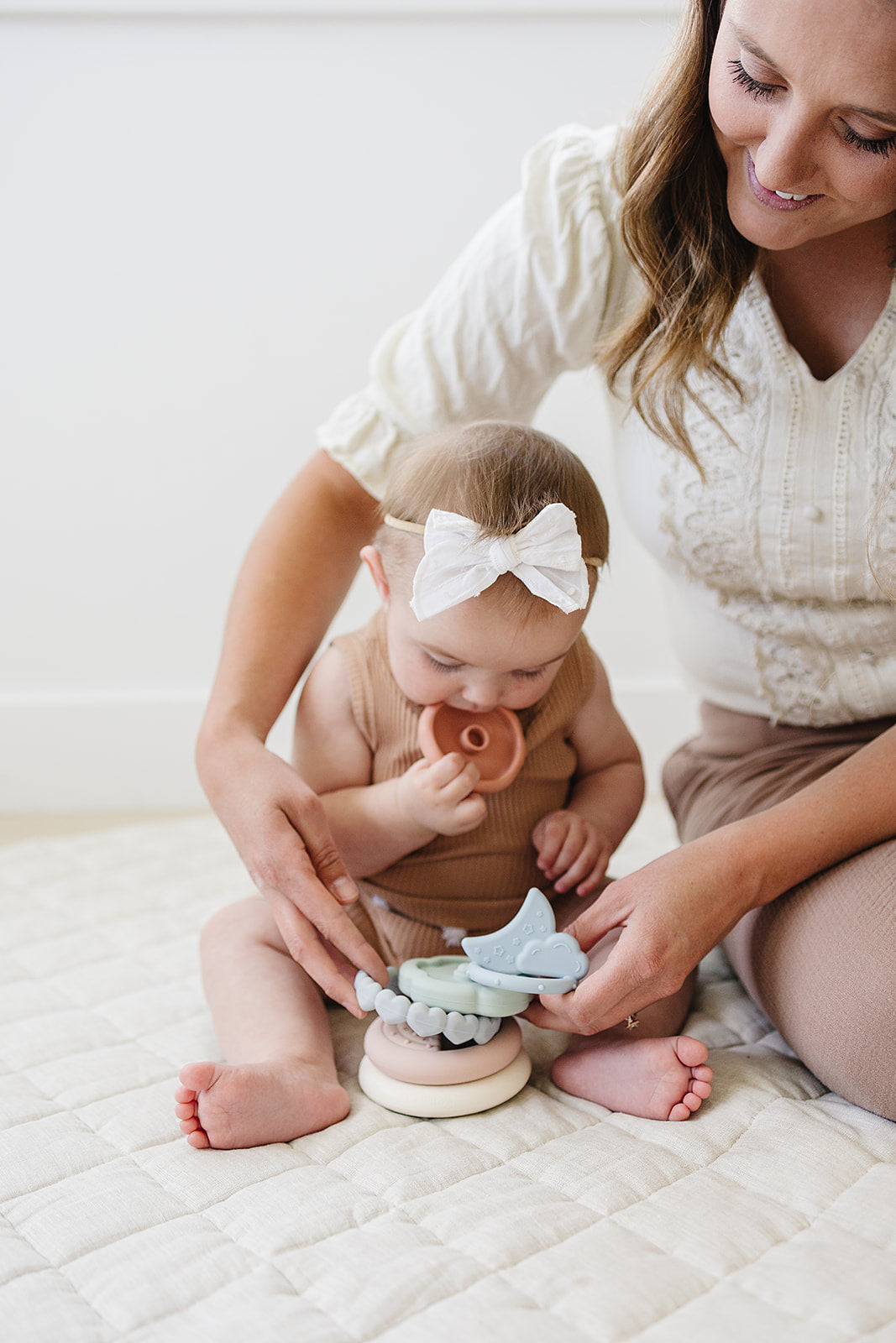 baby playing with soft silicone stacking rings with moon and cloud topper
